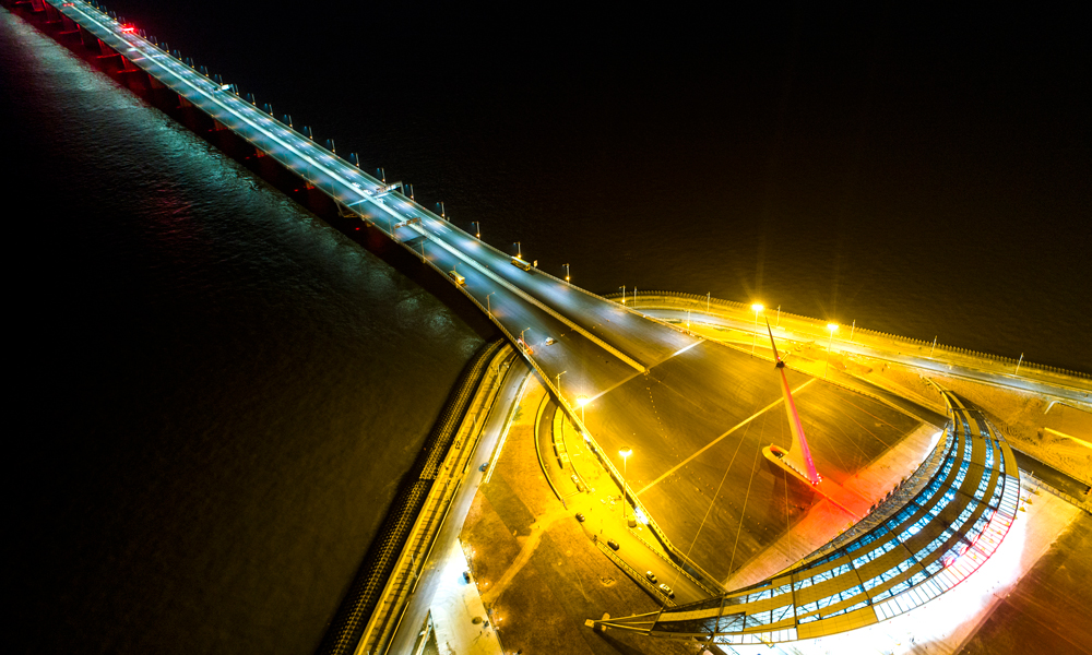 港珠澳大橋上的青州航道橋，巨大的“中國結”造型附近橋面，有一片是用長約1.7米、與大橋等寬的折疊式材料鋪設的。受大風、溫度、車輛等多種負荷作用，大橋會發生一定位移，必須要每隔一定距離設置伸縮縫。交通工程三項頂尖技術中的第三項，便是讓電纜在伸縮縫內做到自由張馳。（史家民 攝）