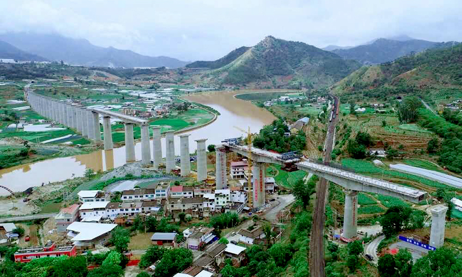 日前，隨著近萬噸重的混凝土轉體橋逆時針緩緩轉動43度，新成昆鐵路沙壩安寧河特大橋成功上跨已經安全運行了50年的老成昆鐵路。在彝族人民的母親河安寧河畔，新、老成昆鐵路實現了交匯，我國西南地區最高的鐵路轉體橋新成昆鐵路沙壩安寧河特大橋轉體成功。圖為大橋轉體完成。