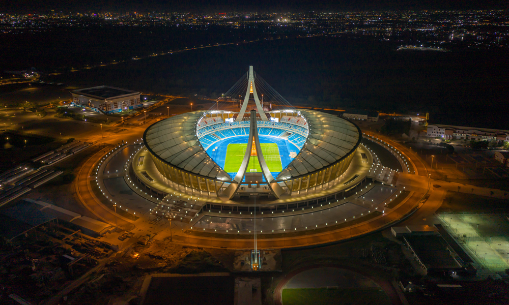 共建“一帶一路”倡議提出十年來(lái)，中國(guó)建筑作為重要的參與者、建設(shè)者，派出了一批批人才、承建了一個(gè)個(gè)項(xiàng)目，與沿線國(guó)家和地區(qū)一起完善當(dāng)?shù)鼗A(chǔ)設(shè)施，推動(dòng)產(chǎn)業(yè)發(fā)展，構(gòu)建起便利當(dāng)?shù)厝罕姷拿裆?wù)網(wǎng)絡(luò)，為“一帶一路”沿線一批重大項(xiàng)目建設(shè)提供中國(guó)建造方案，貢獻(xiàn)中國(guó)智慧。圖中的柬埔寨國(guó)家體育場(chǎng)由中建八局承建，坐落于柬埔寨首都金邊的市郊，占地面積16.22公頃，總建筑面積8萬(wàn)多平方米，可提供60000個(gè)座位，是中國(guó)迄今對(duì)外援建的規(guī)模最大、等級(jí)最高的體育場(chǎng)。