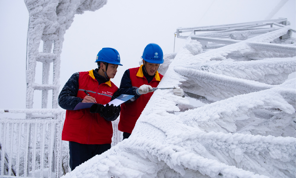 國家電網(wǎng)紅巖（重慶城口）共產(chǎn)黨員服務(wù)隊(duì)在觀冰點(diǎn)測量220千伏華城線模擬導(dǎo)線覆冰厚度。
